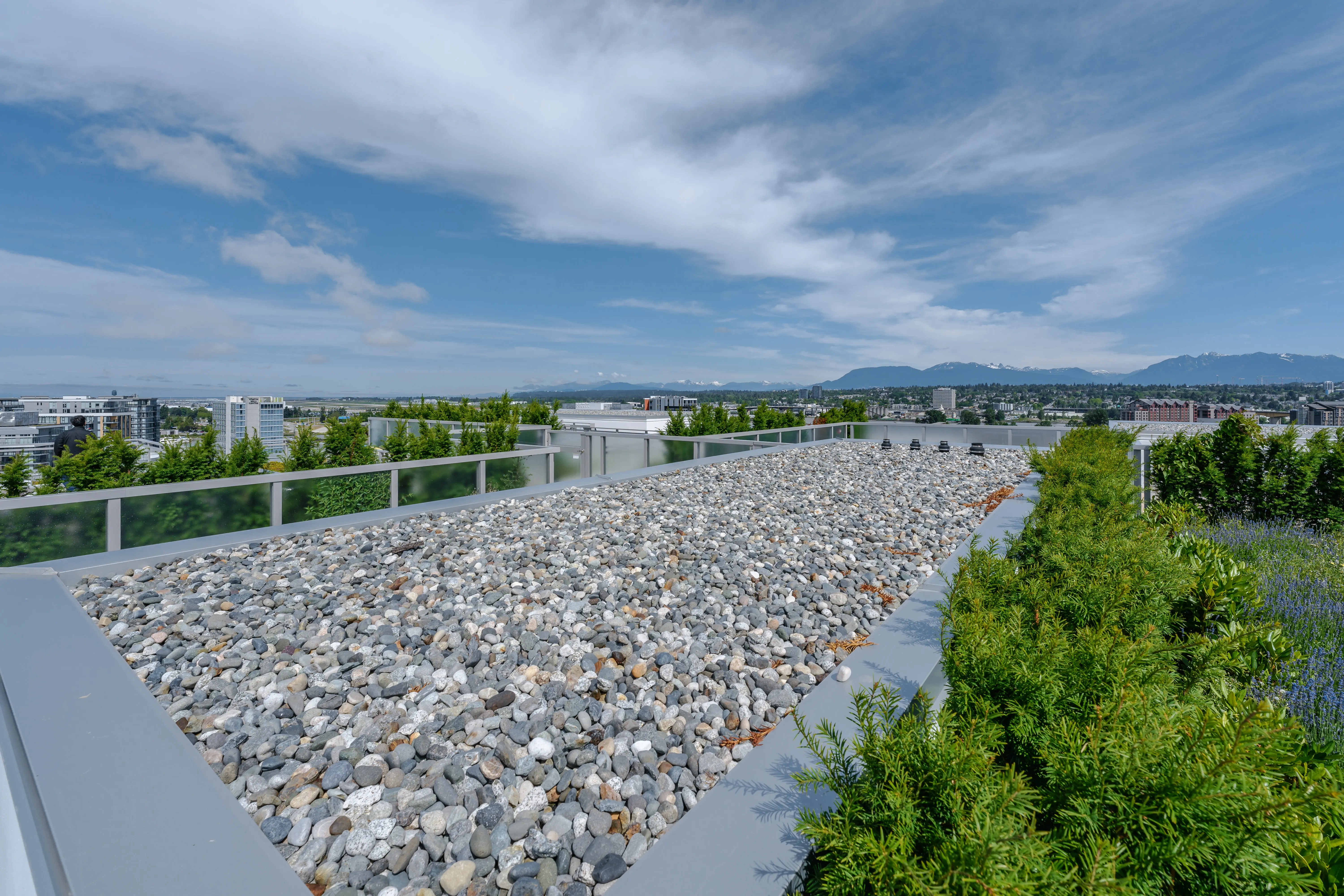 Gravel roof edge with planting and mountain views at Torino