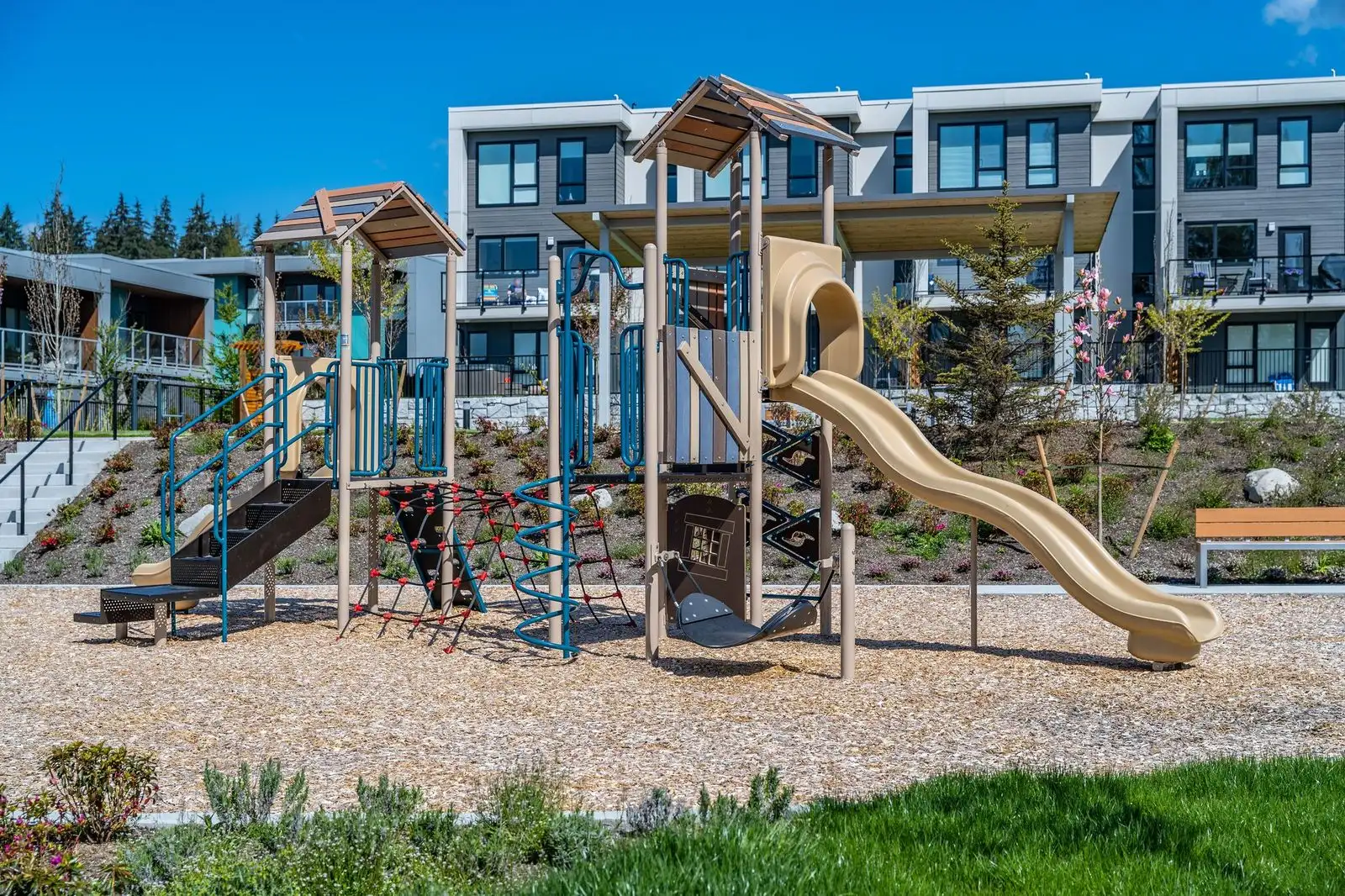 Play structure with slides on a wood chip surface at Seymour Village Amenity Park