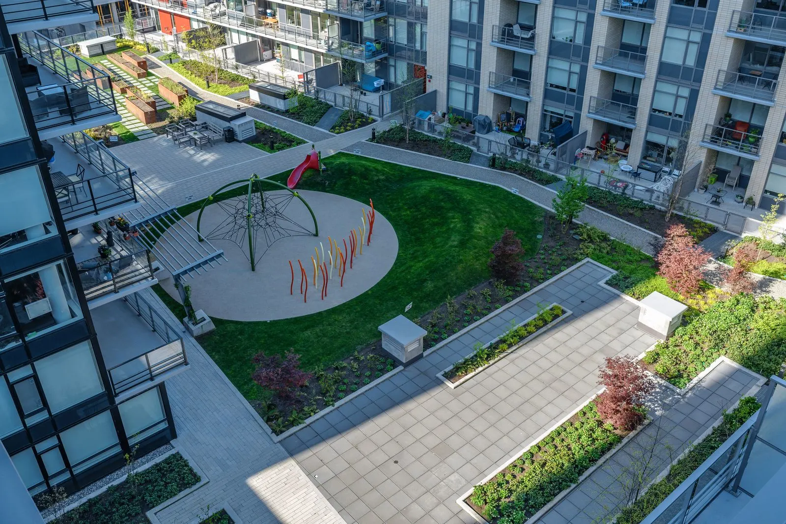 Overhead view of a courtyard with lawn, play area and paths at Quartet