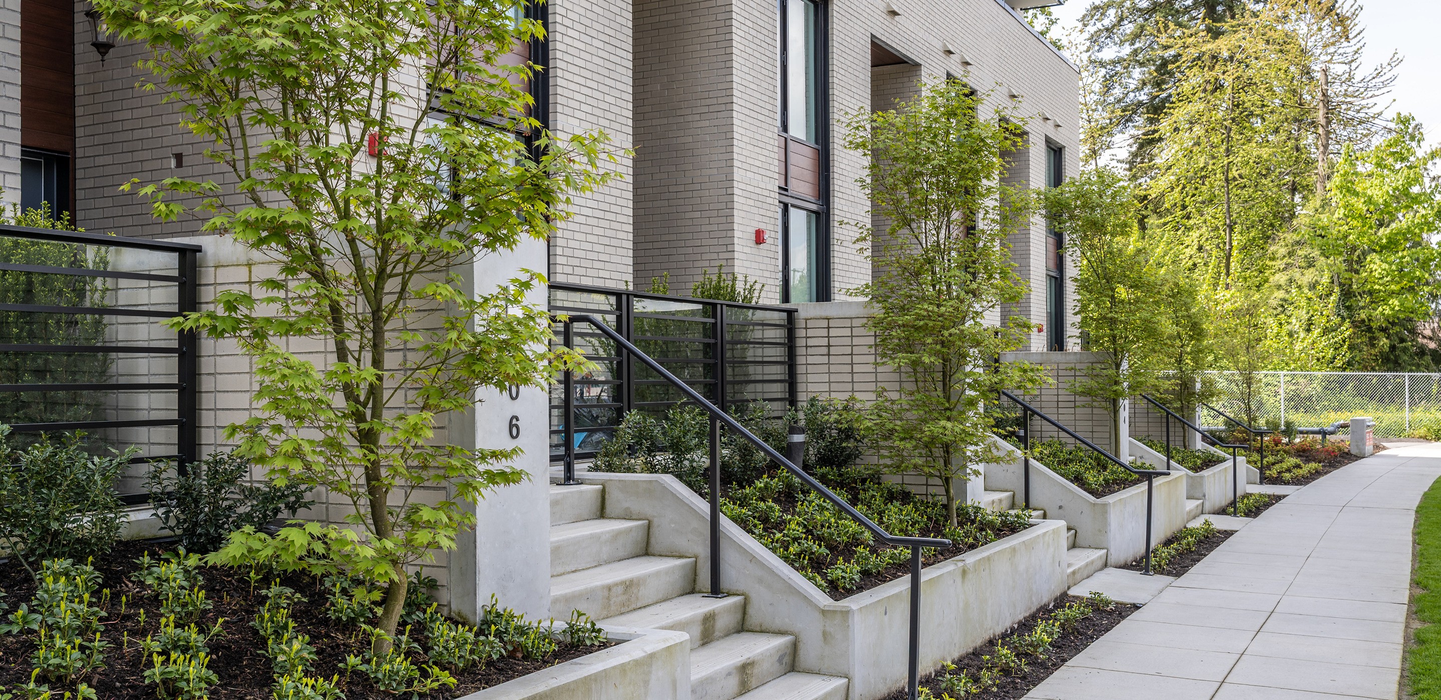 Townhome entry stairs and planting along a sidewalk at Melrose