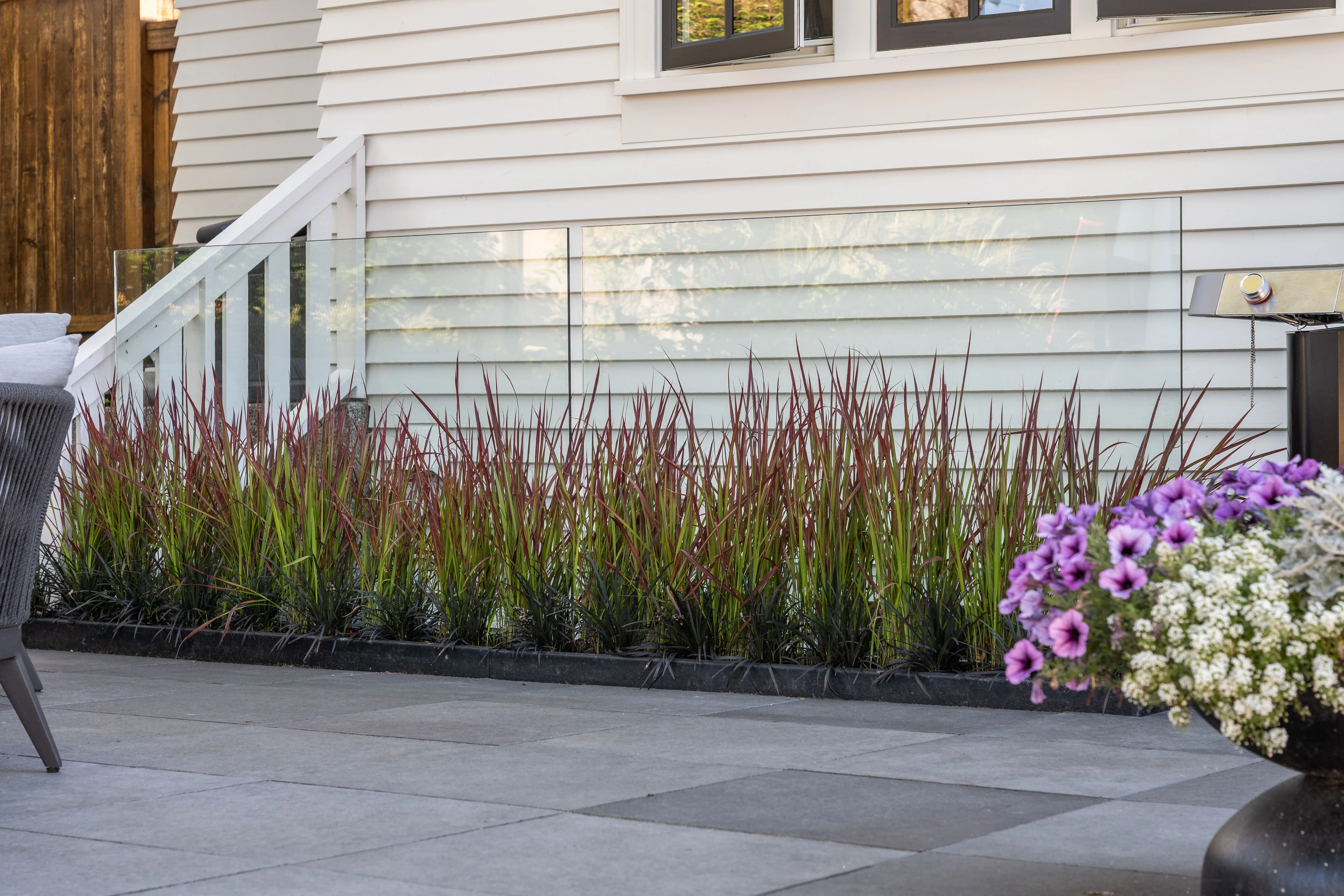 Grass and flowering planting along a patio edge at MacKenzie