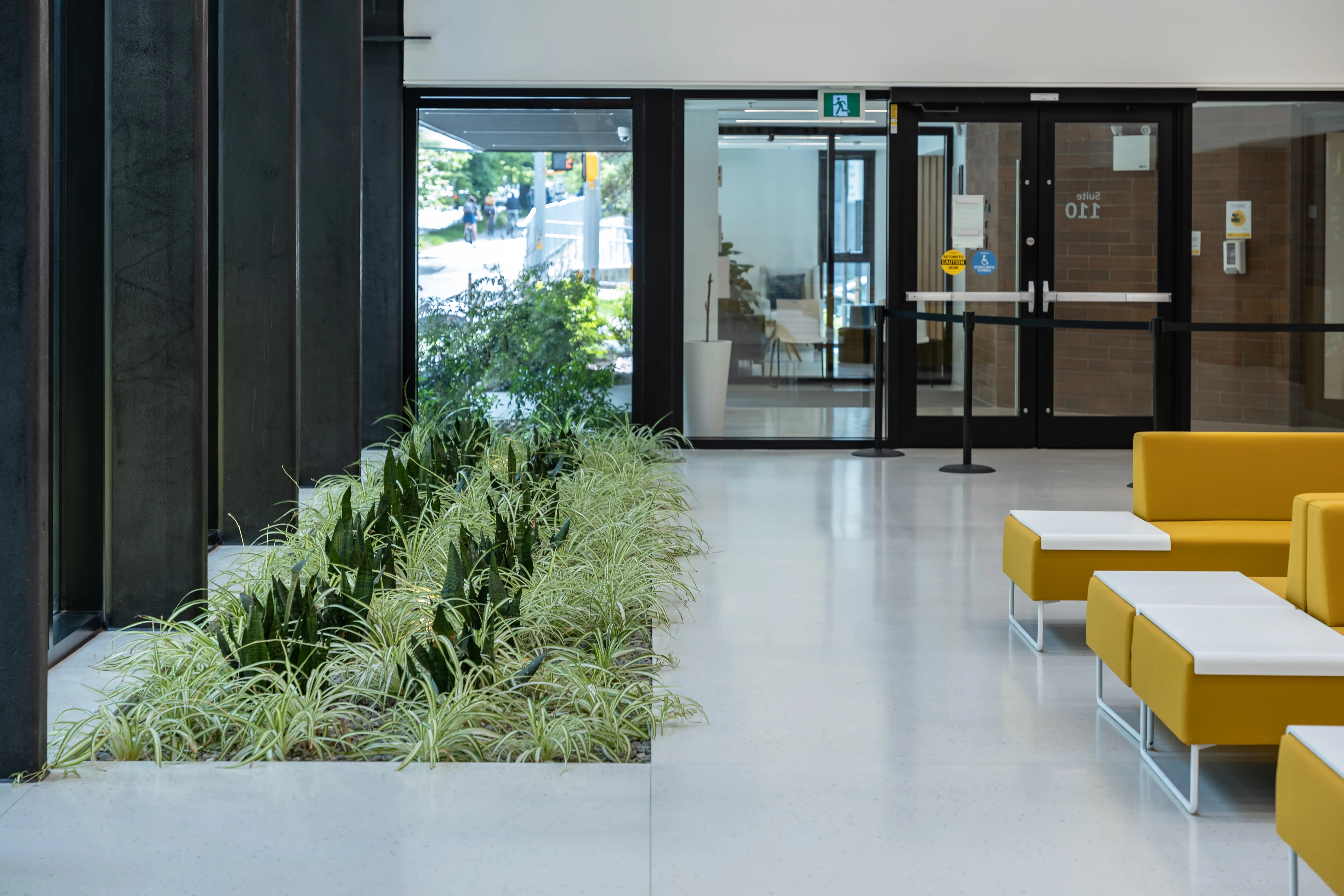 Interior lobby with an indoor grass planter and seating at Canadian Cancer Society