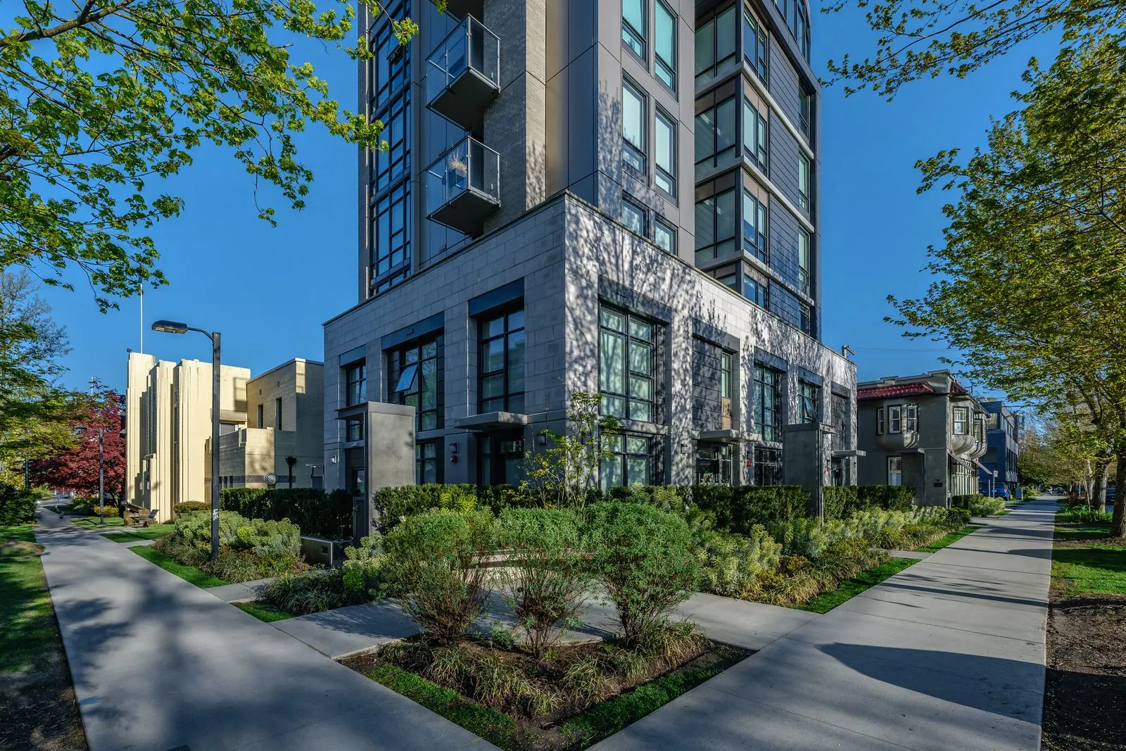 Corner walkways and planting beds at the base of a tower at Eleven West