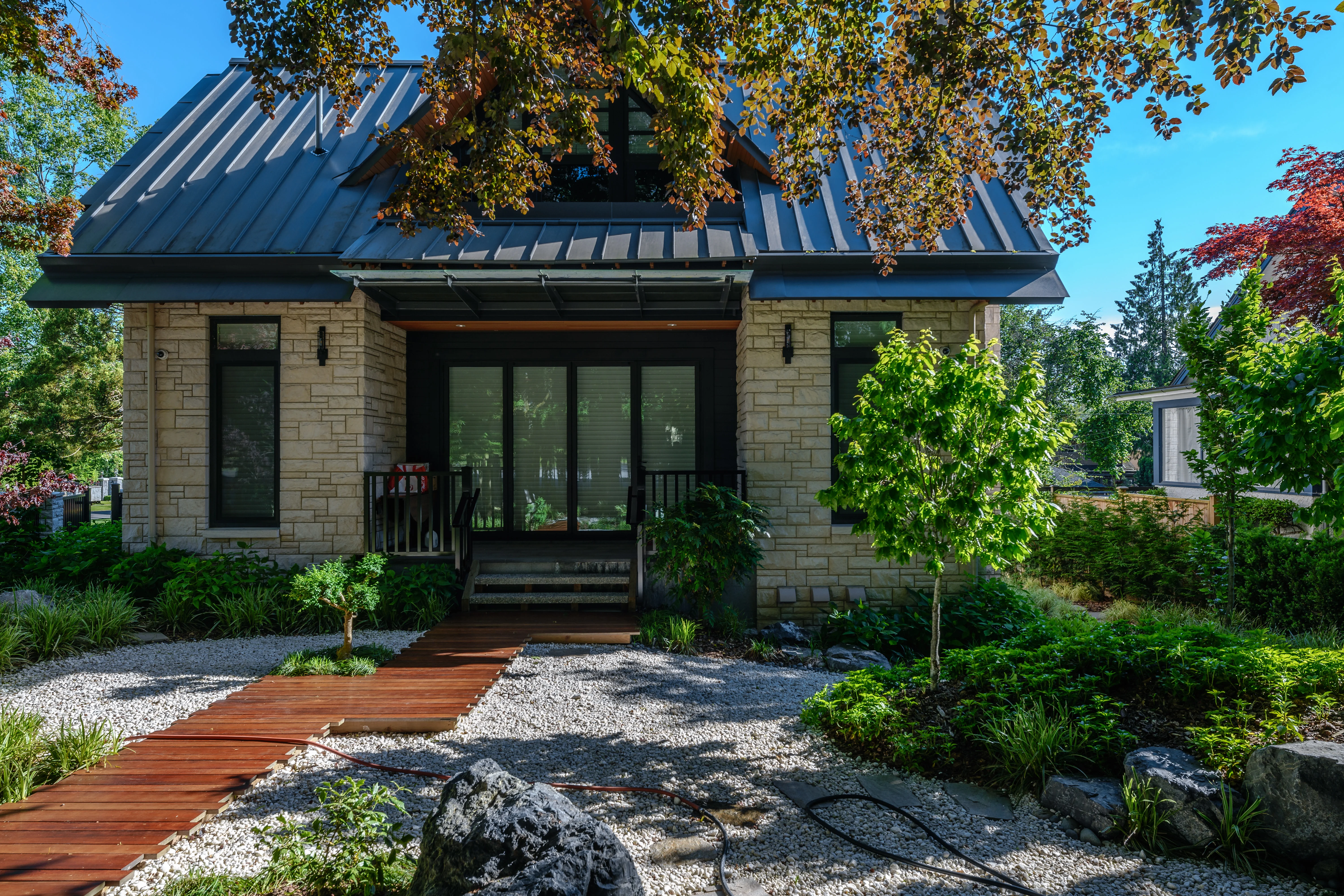Timber path and gravel garden leading to a house at Hudson Street