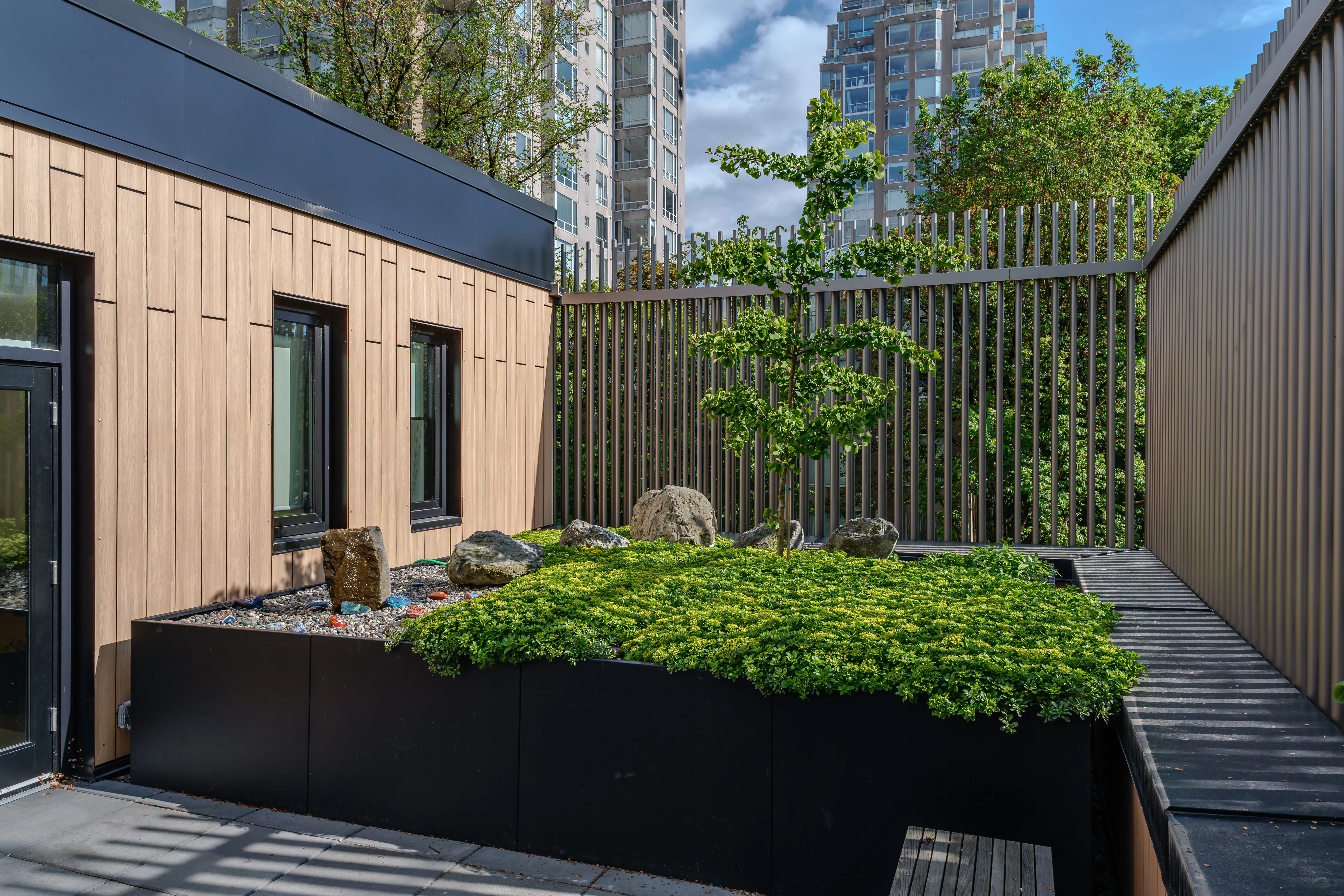 Raised planter on a fenced patio beside a building at Canadian Cancer Society