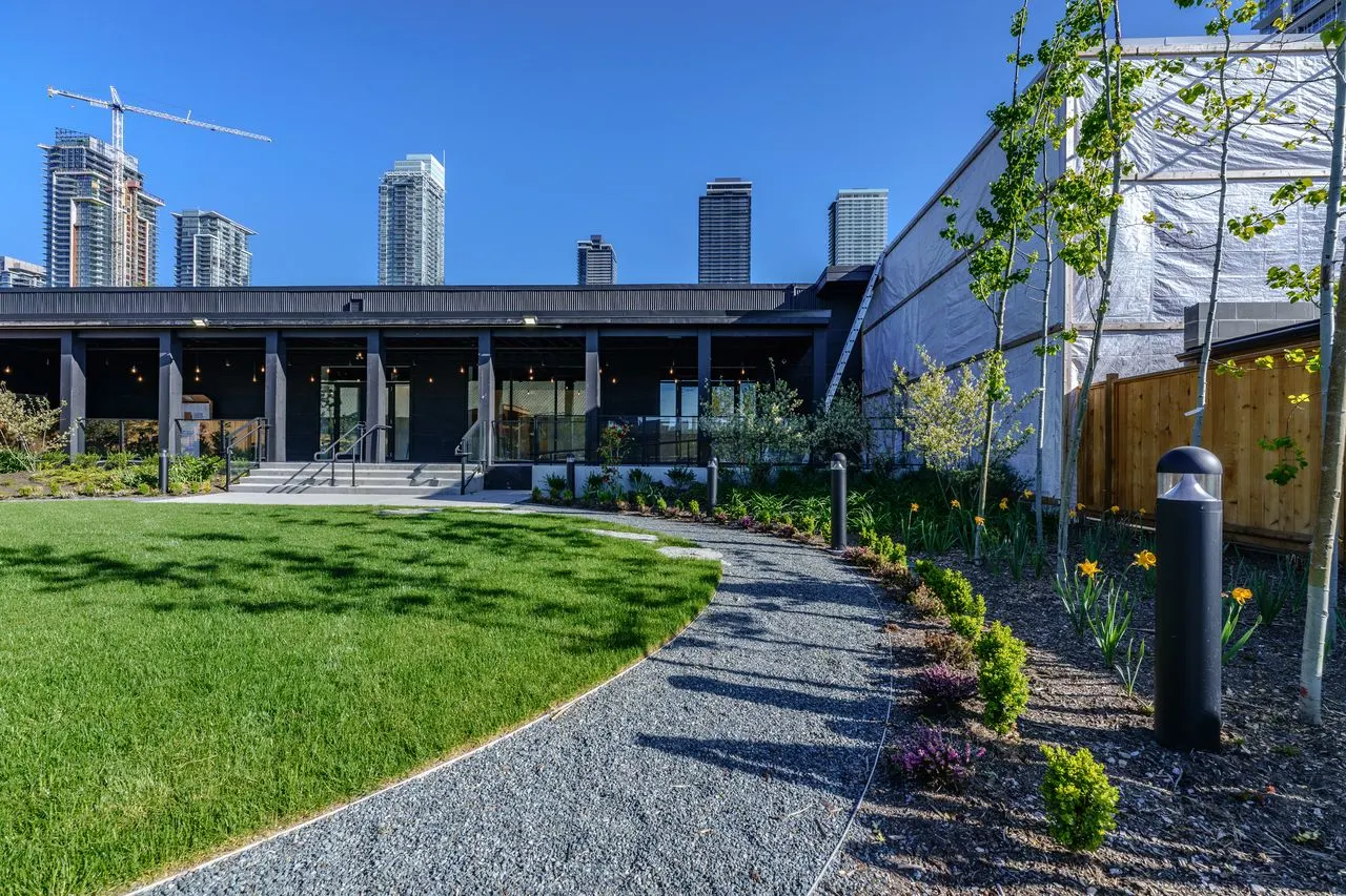 Curving gravel path around a lawn at The Grove Presentation Centre