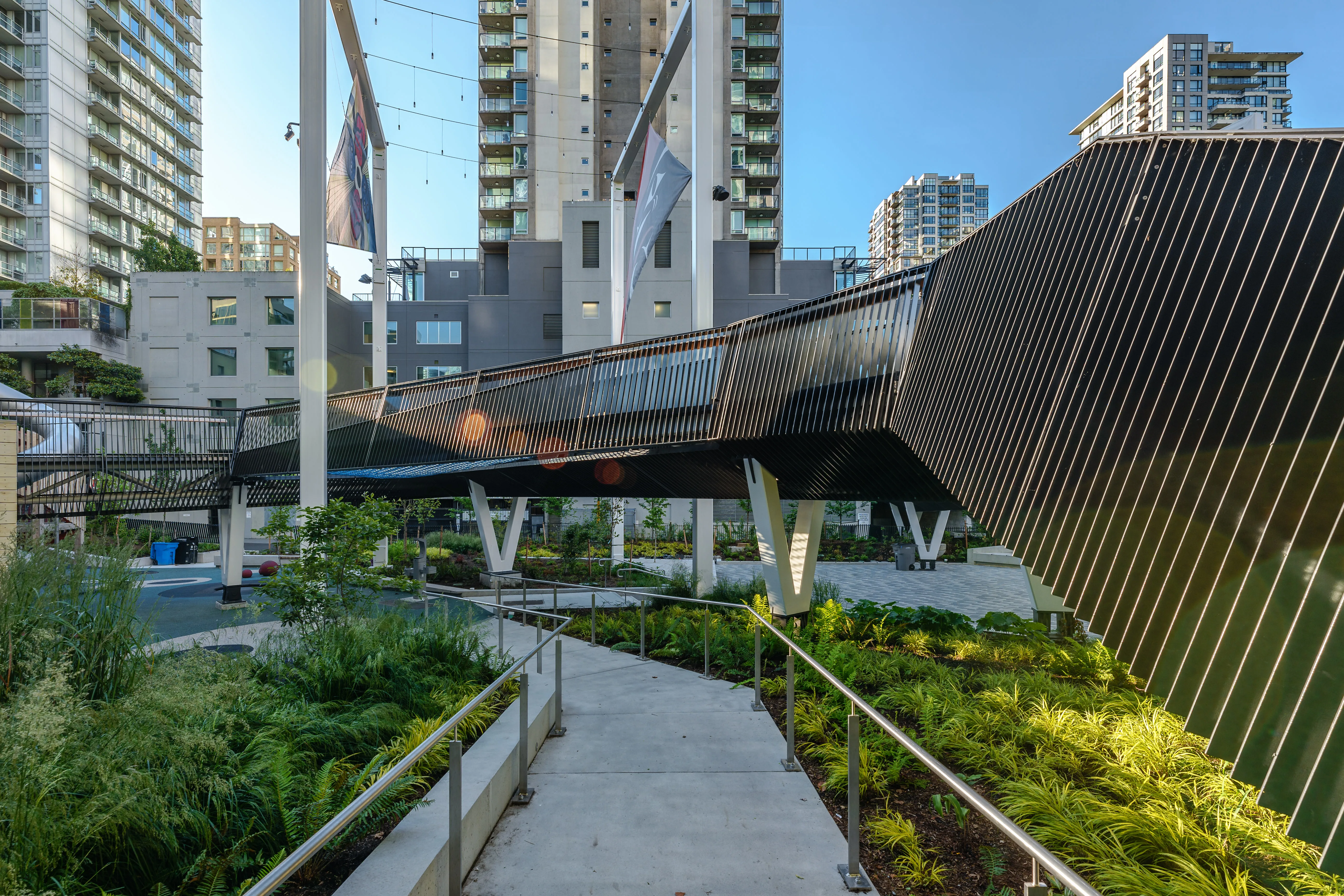 Pathway through planting under an elevated walkway at Rainbow Park Downtown