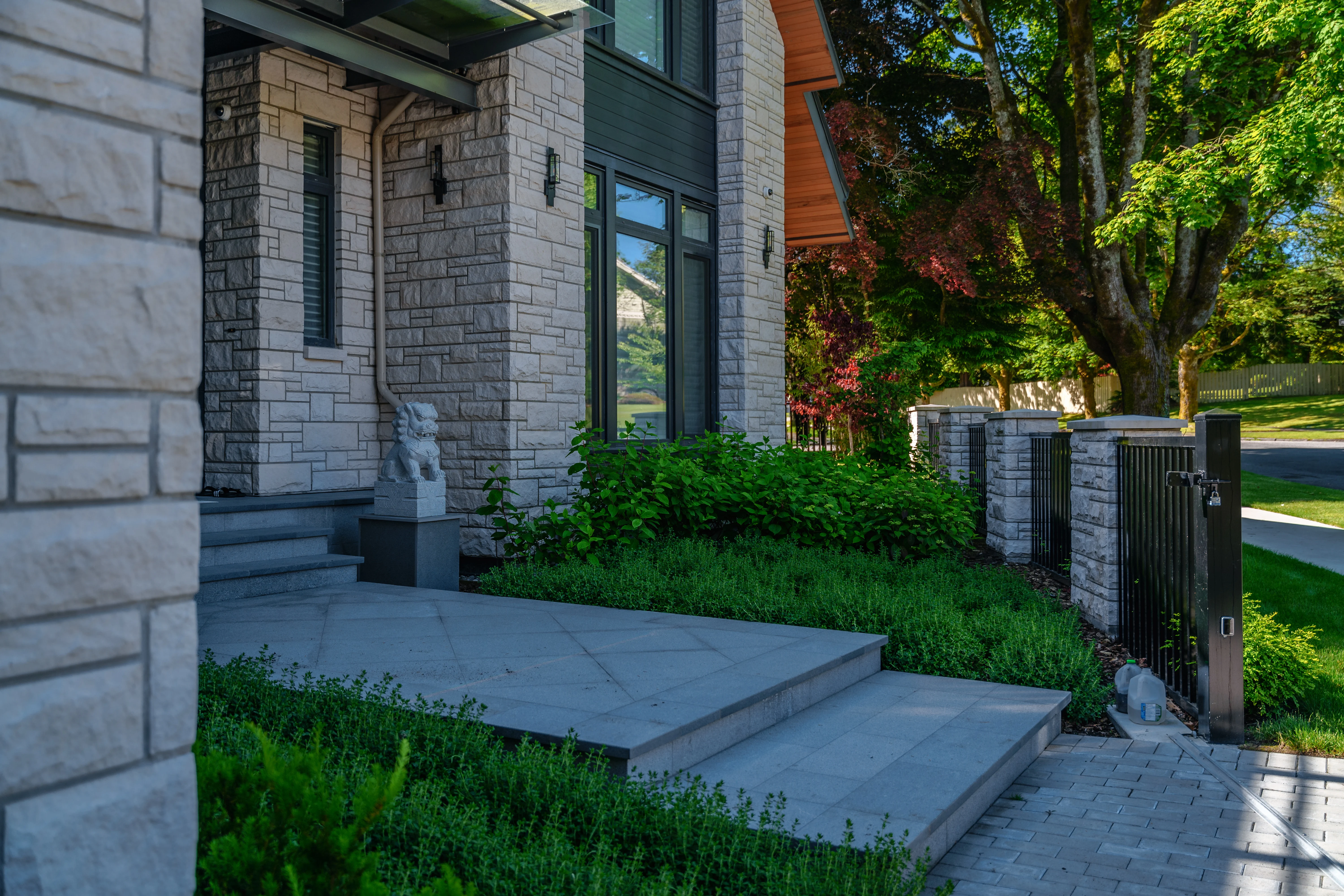 Stone entry steps with low planting and hedge at Hudson Street