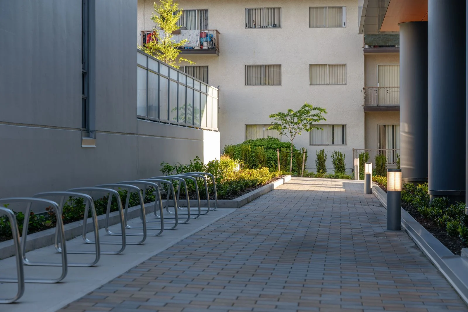 Paved courtyard with bike racks and planters at Sun Tower II