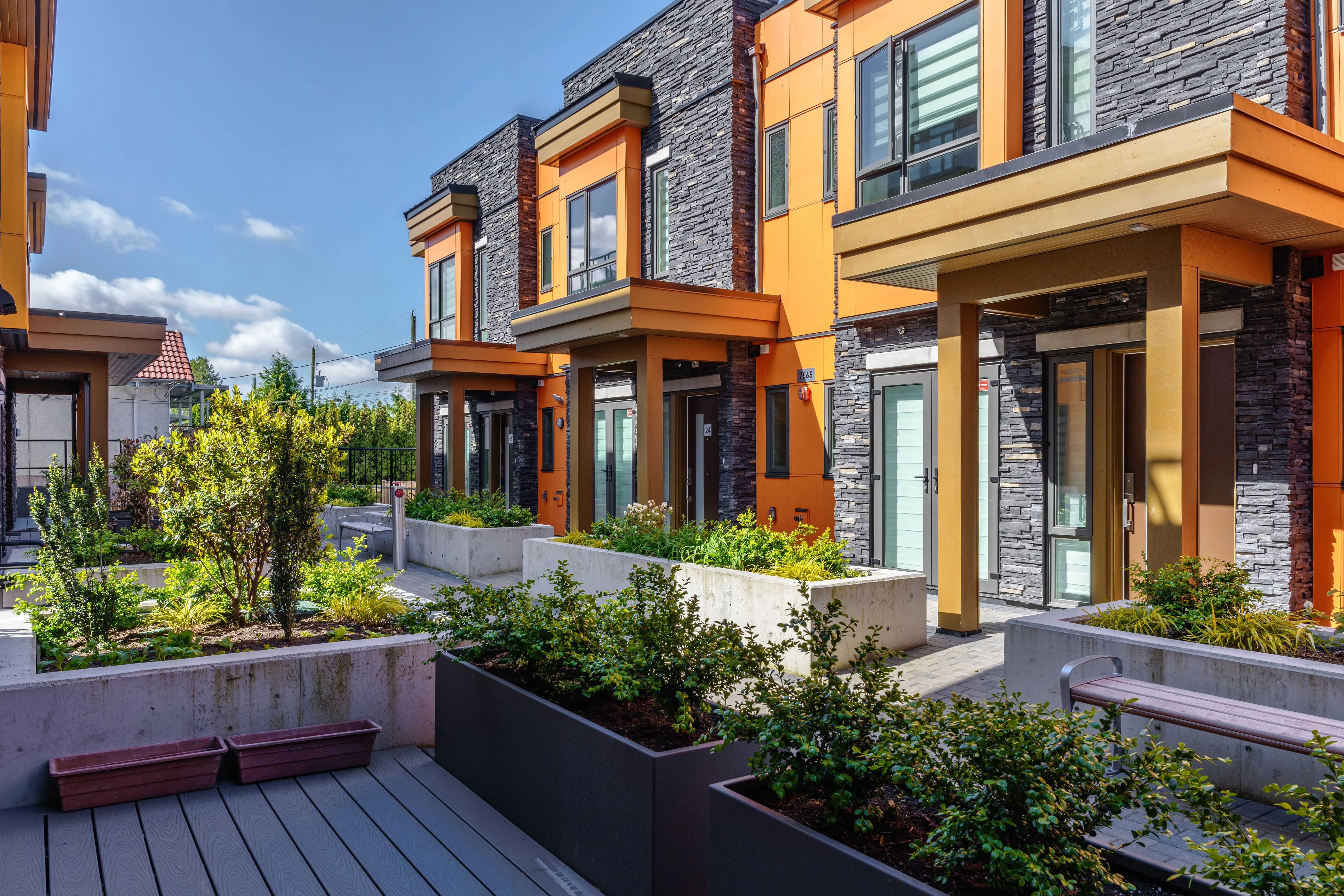 Planters and timber decking along townhome patios at Terraces at Oak Park