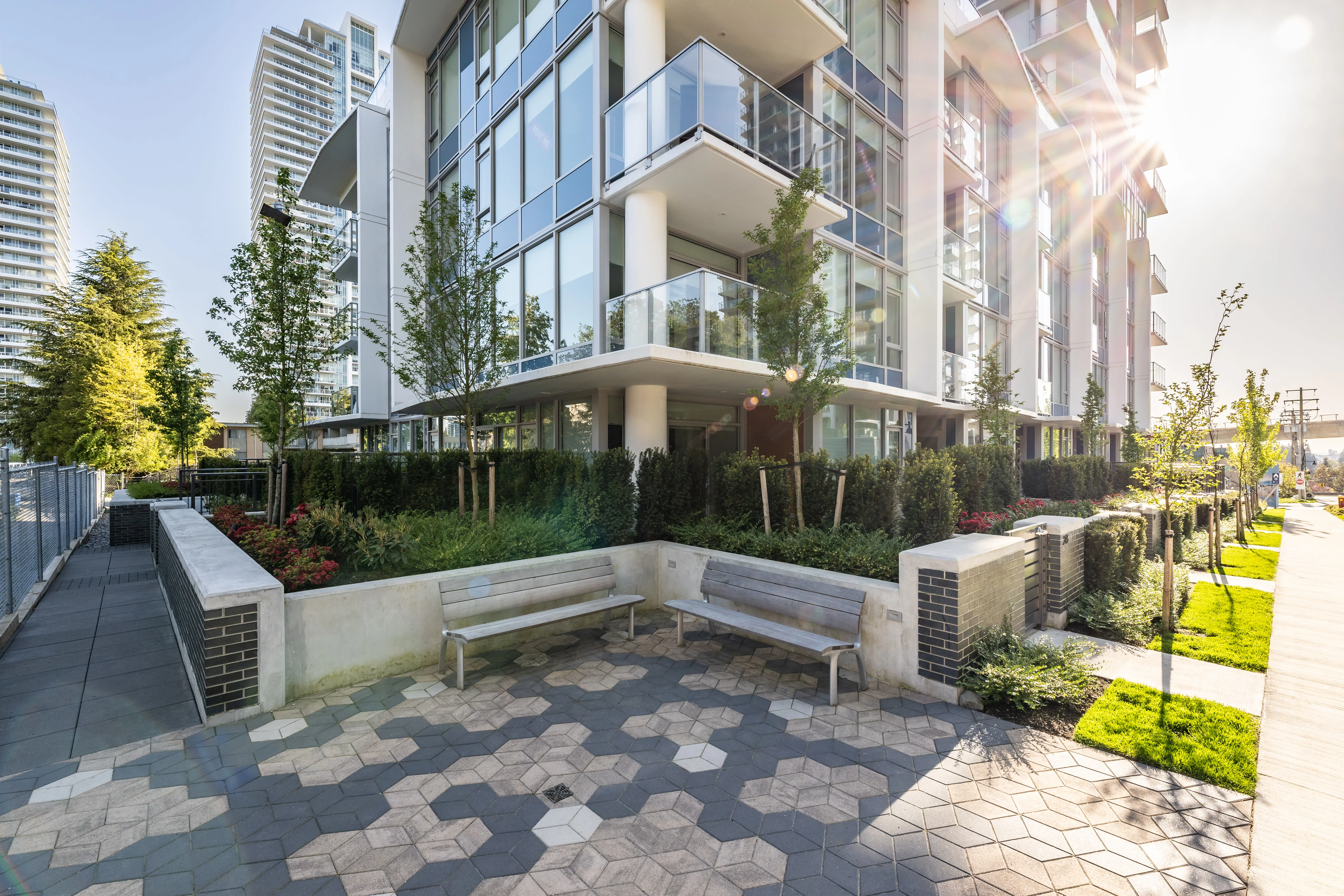 Hexagonal paver plaza with planting and seating at Precidia