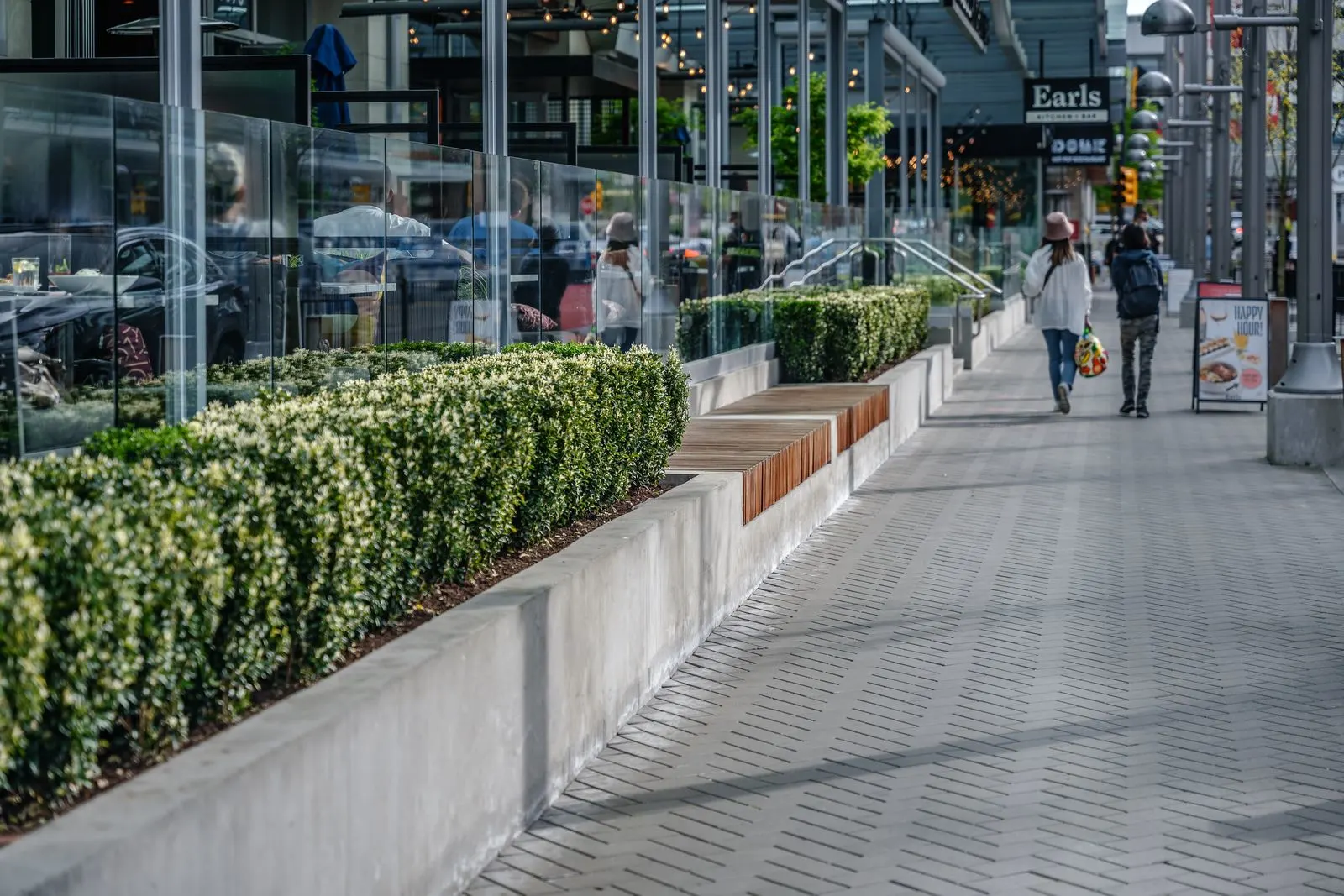 Hedge planters and timber benches along a retail sidewalk at Station Square 2 and 3