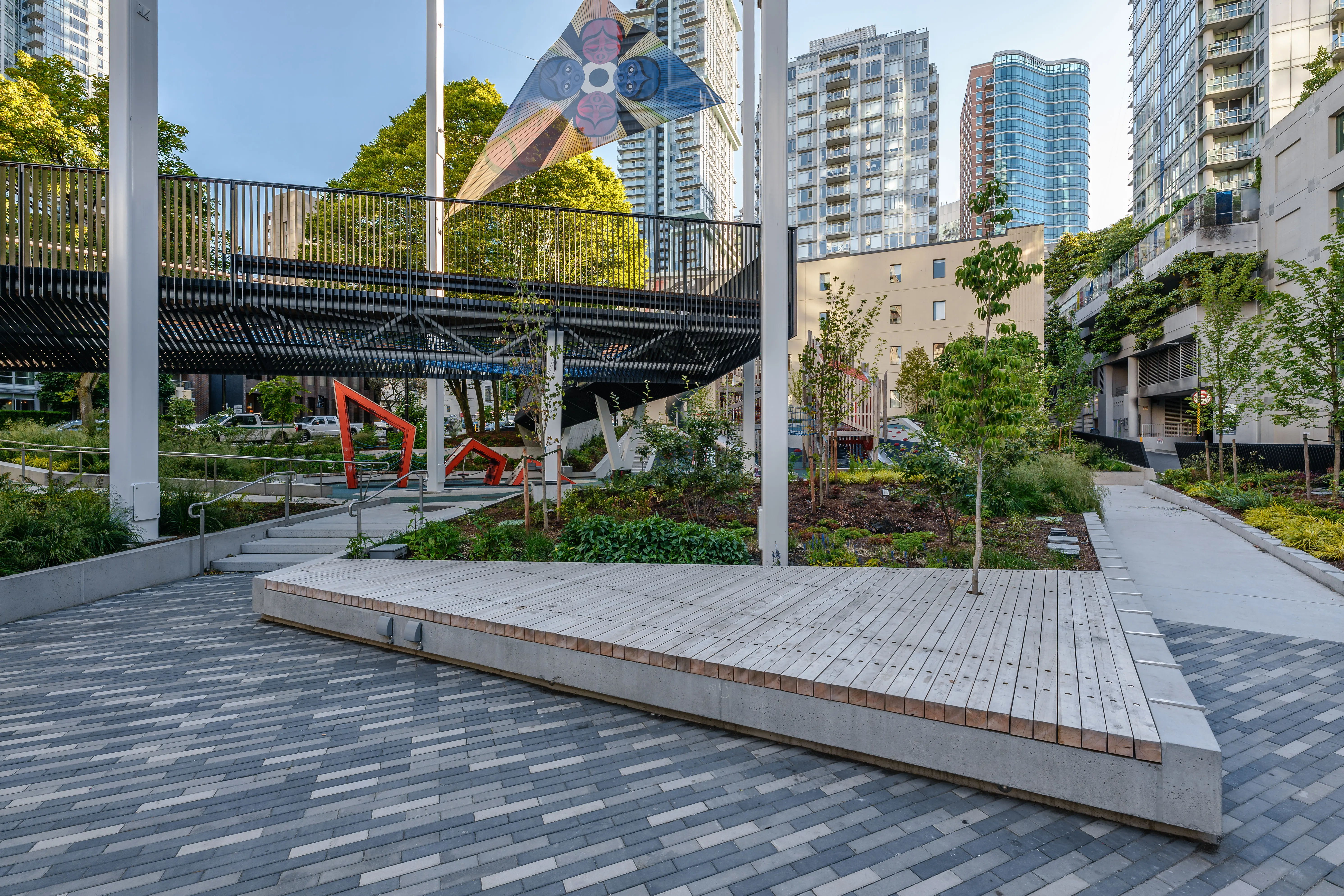 Timber deck platform on a paved plaza in a park at Rainbow Park Downtown