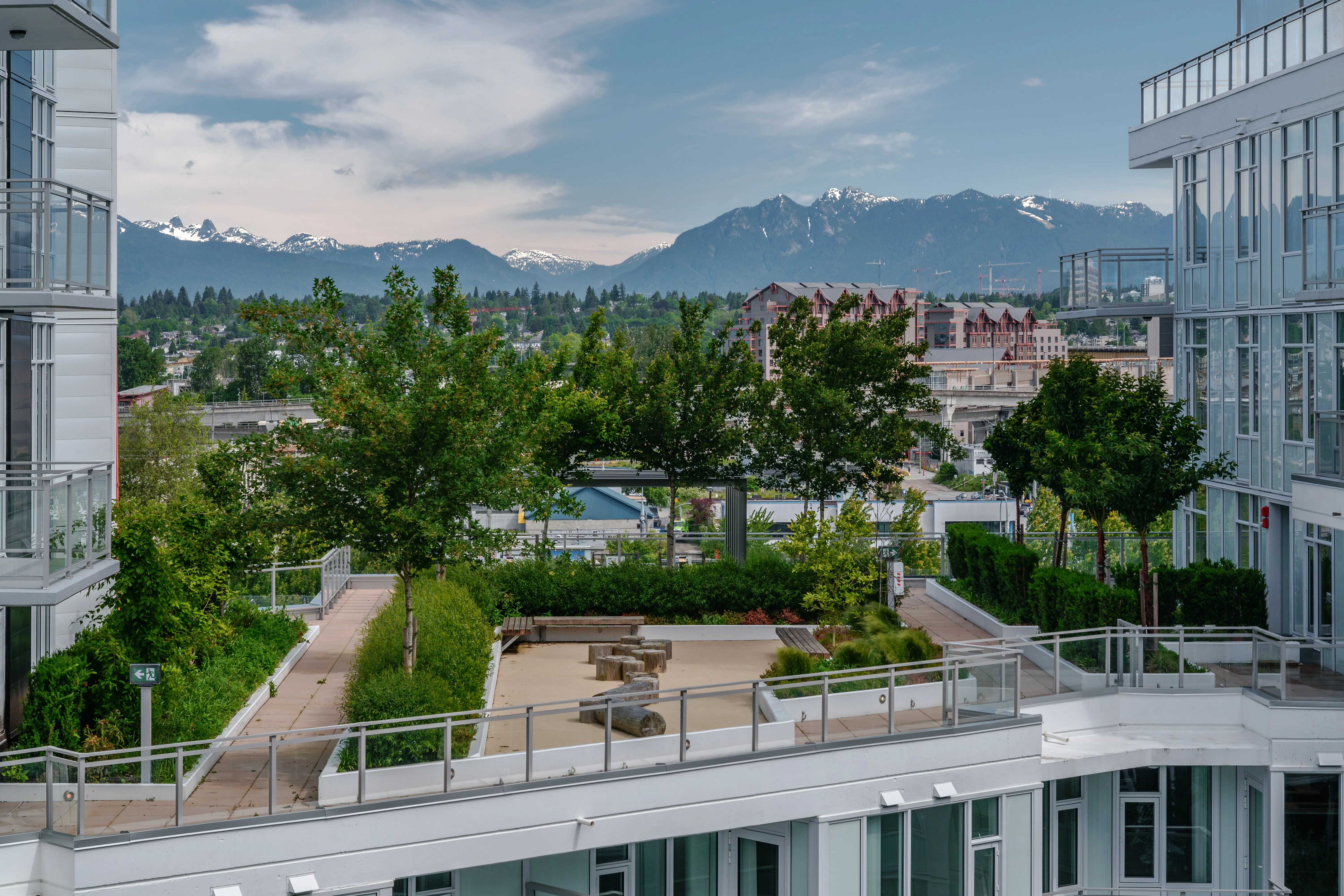 Courtyard landscape with trees and mountain views beyond at Torino